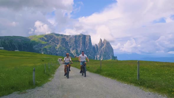 Couple Men and Woman on Vacation in the Dolomites ItalyAlpe Di Siusi  Seiser Alm South Tyrol Italy alt