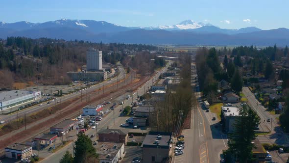 Drone View of a Scenic Mountain Town near Mt Baker as Cars Drive on the Streets Below alt