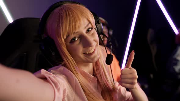 Joyful Young Caucasian Woman Sitting in a Gaming Chair During an Online Gaming Event with Big alt