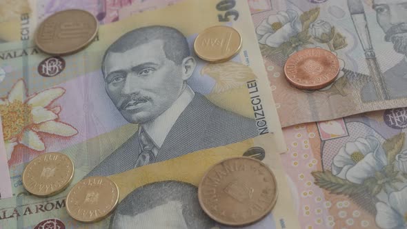 Tilting over Romanian lei paper national currency and coins 3840X2160p 30fps UltraHD  video - Close- alt