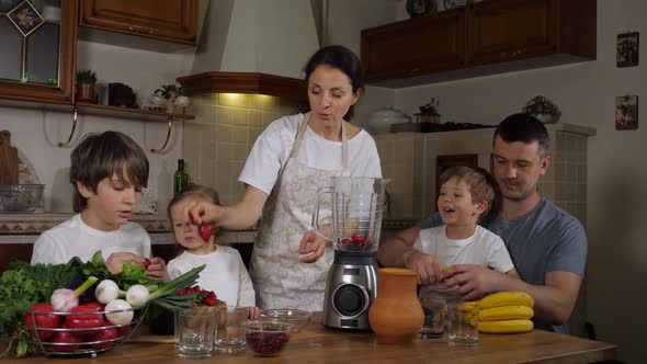 Children with Parents is Preparing a Smoothie at Domestic Kitchen Together