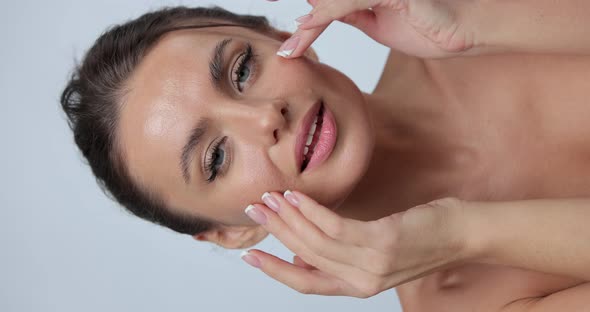 Vertical POV Video of Beauty Portrait of Young Woman with Smooth Healthy Skin She Gently Touches Her alt
