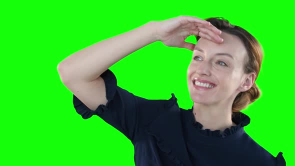 Caucasian woman raising hand on green background