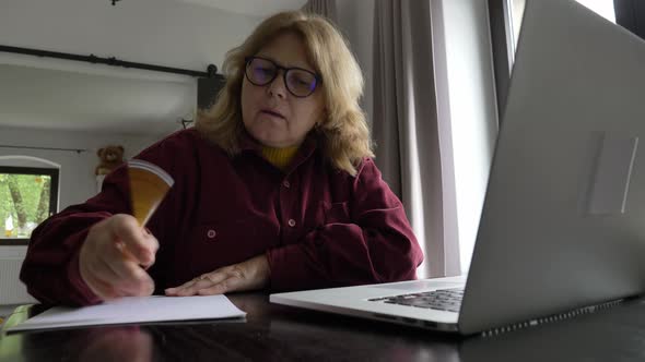 senior woman using laptop computer at home.