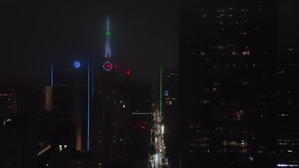 Drone Flying Along Street Between Tall Commercial Buildings Around Mercantile National Bank Building alt