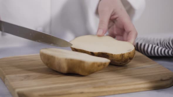 Time lapse. Step by step. Slicing russet potatoes in wedges with olive oil and spices to bake in the alt