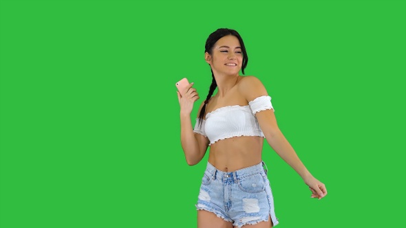 Positive Pretty Sexy Girl Listening to Music on Her Phone alt