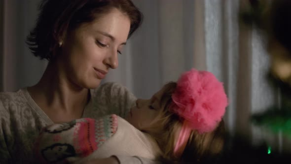 New Year. Little Girl Sleeping In Mom's Hands. alt