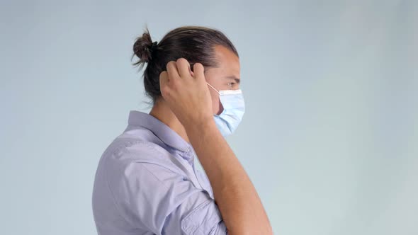 Profile Shot of a Young Male Man Putting His Mask On, Medium shot alt
