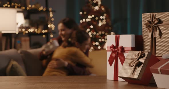 Mother and daughter exchanging Christmas gifts