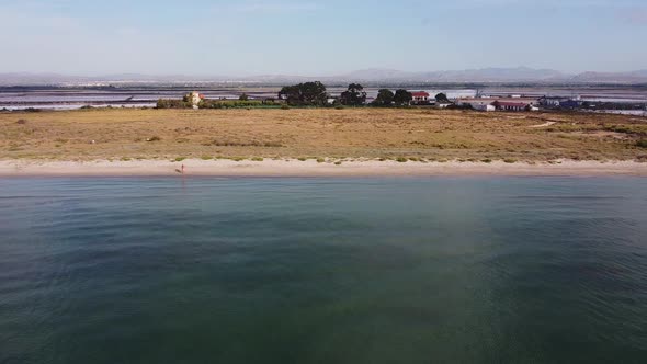 Flying along a beach and saltworks in Santa Pola, spanish Mediterranean alt