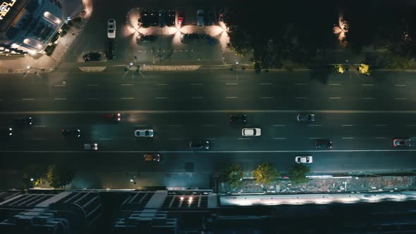 Cars Drive Through the Streets of the Night City