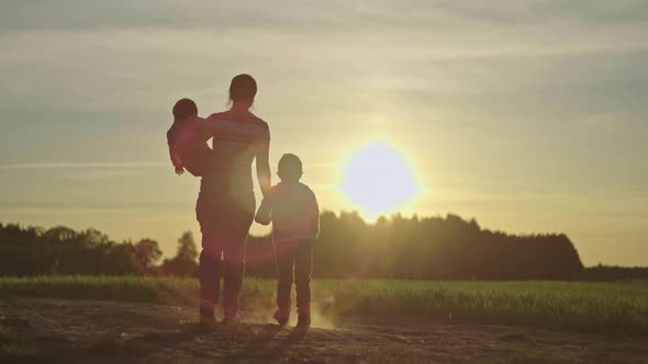 Happy Family Together in Nature at Sunset alt