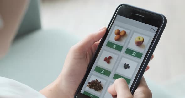 Ordering Food Vegetables and Fruits Online Using Smartphone App Close Up alt