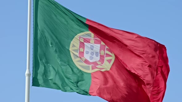 National Flag of Portugal Waving in the Wind on Clear Sunny Day at Blue Sky
