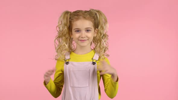 Lovely Blond Curly Girl Is Clapping Her Hands alt