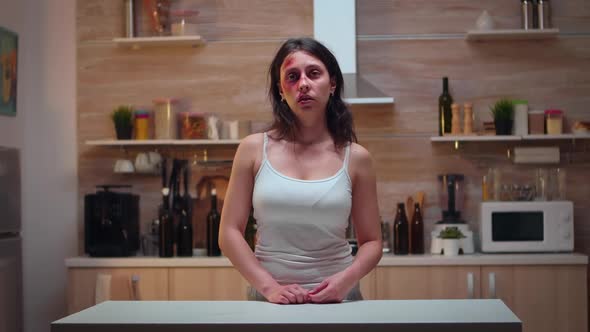 Traumatised Woman Sitting in the Kitchen alt