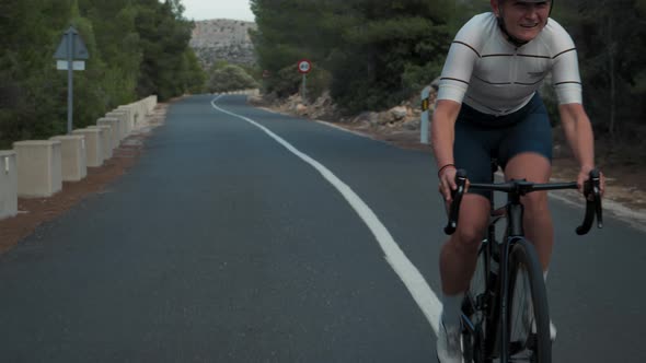 Young Pro Female Cyclist on Intense Road Training