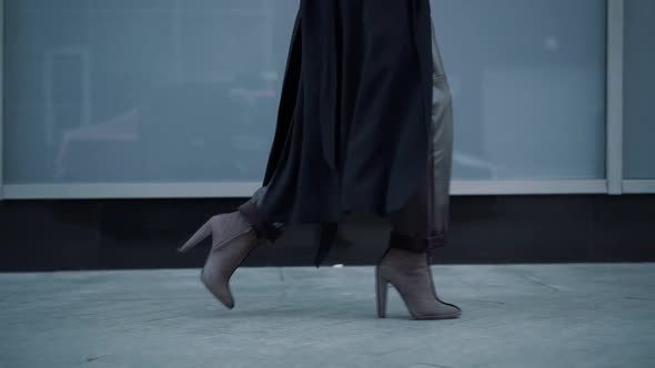 Slow Motion Gimbal Shot of Woman Boots on City Pavement