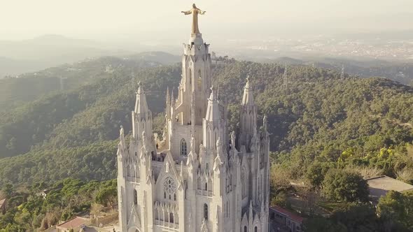 Tibidabo Church With Jesus Statue In Barcelona. Aerial shot at sunset. alt