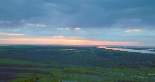 Beautiful Sunrise or Sunset Above Green Fields and River Aerial View Over Woodland  Prores
