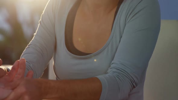 Physiotherapist giving hand massage to patient alt