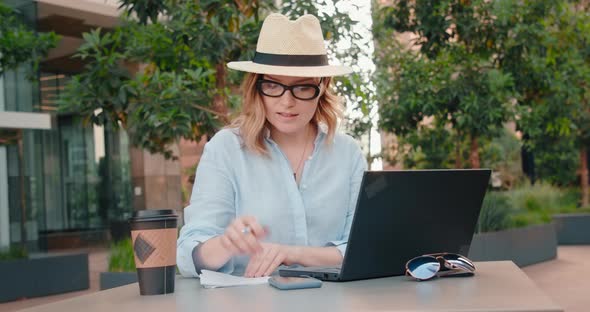 Serious Female Entrepreneur Writing Down To Do List To Achieve Her Goals,  USA alt