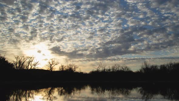 Brilliant Sunrise Clouds Over Lake Zoom Out Timelapse