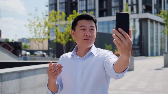 Handsome Asian Male Person Make Online Conference Call Shooting Video Outside alt