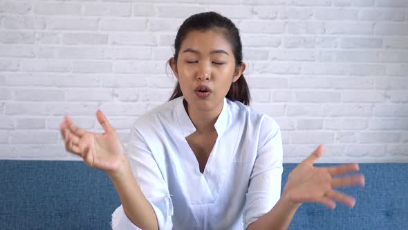 Happy Friendly Asian Woman Looking at Camera and Talking Making Video Call Conference at Home alt