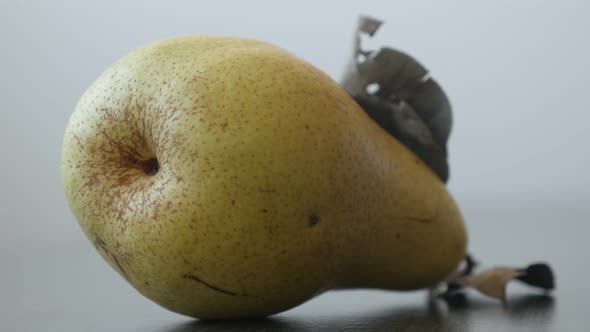 Yellow organic pear on the table 4K 2160p UltraHD tilting footage - Single fruit from genus Pyrus sl