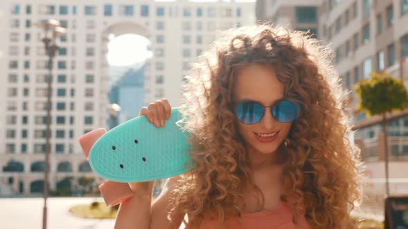 Young beautiful sexy smiling hipster woman with afro curls hairstyle posing outdoors alt