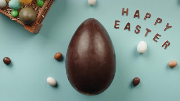 Hand Opens a Chocolate Easter Egg with a Gift Rabbit Inside alt