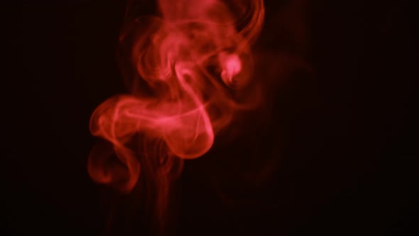 Red Smoke in Slow Motion. Flowing Abstract Steam in Dark background. Dramatic Emotional