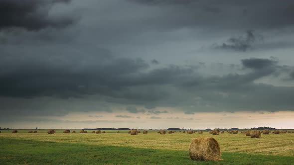 Sky Before Rain With Rain Clouds On Horizon Above Rural Landscape Field Meadow With Hay Bales After alt