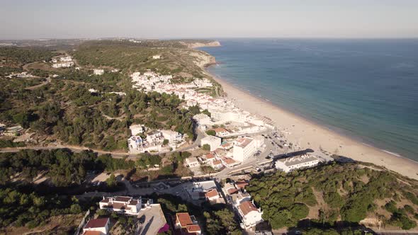 Charming old fishing village of Salema, Algarve. Long sand beach and emerald ocean. Aerial alt