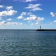 Light house in the far distance on a sunny day - VideoHive Item for Sale