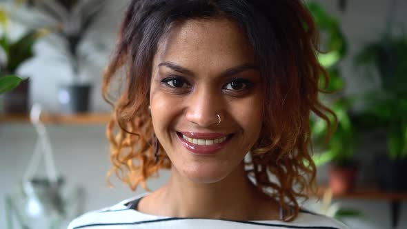 African Woman Posing on Background of Green Plants at Home Interior Spbd alt