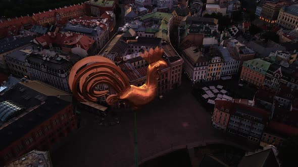 Aerial Top View Golden Weather Cock in Riga Old Town During Amazing Scenic Sunrise Aerial alt