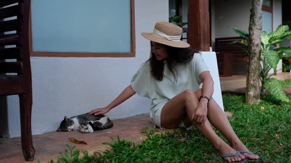 Slow motion of a woman playing with a little cat while sleeping