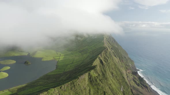 Aerial view of Caldeirao, a lake along the coastline on Corvo island, Azores islands, Portugal. alt