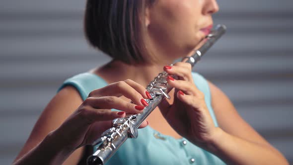 Musician Female in Spotlight Playing on Flute