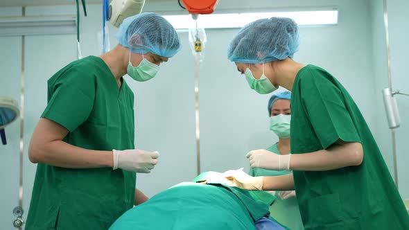 Professional surgeons team performing surgery in the operating room, surgeon, Assistants, and Nurses alt