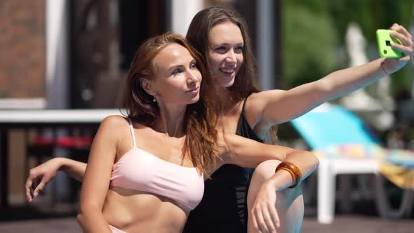 Slim Selfish Caucasian Women Taking Selfie on Smartphone Sitting at Luxurious Resort in Sunshine alt