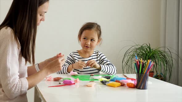 Mother and Daughter Playing with Modelling Clay Together