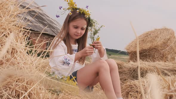 Girl Sitting on Hay alt