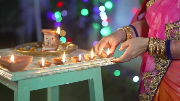 A Women Lighting a Lamp