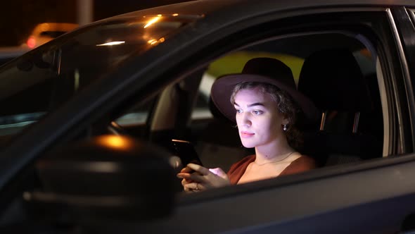 Young Woman Using Smartphone in Car
