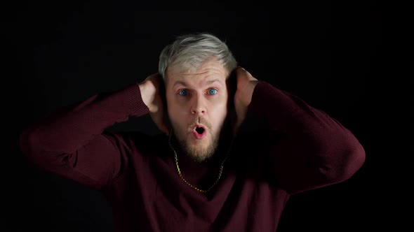Shocked Surprised Stylish Man Feeling Excitement Looking at Camera and Holding Hands Near Face alt