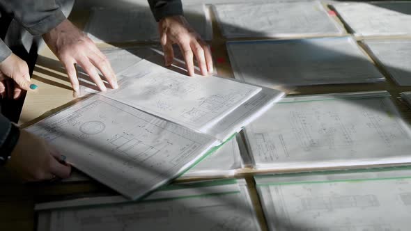 Engineer Is Learning Technical Working Drawing of Detail for Production in Office alt